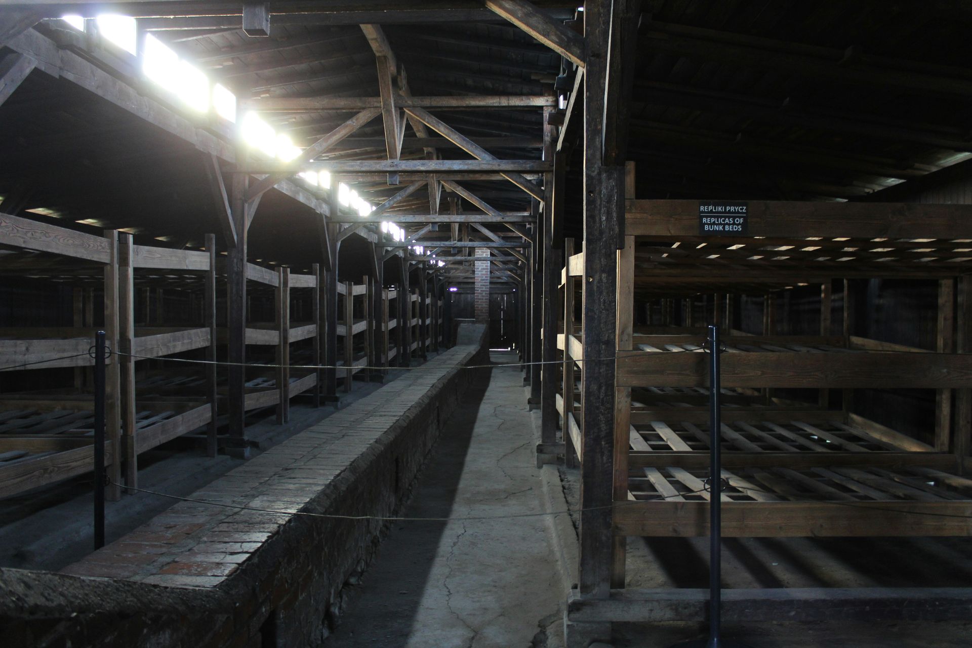 A large factory interior; a crane lifts a metal frame.