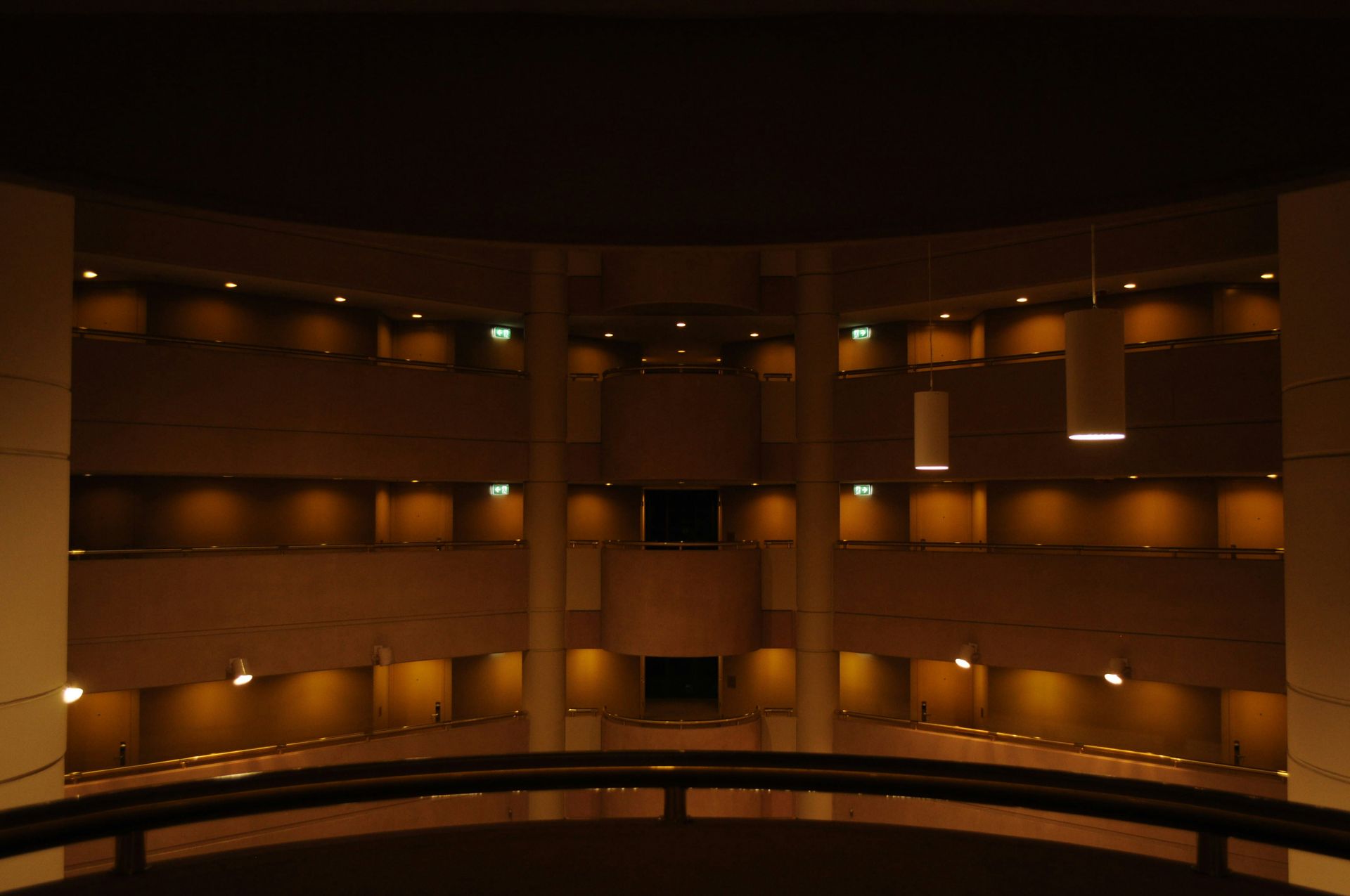 Warehouse interior with forklifts moving pallets, rows of storage racks, and concrete floor.