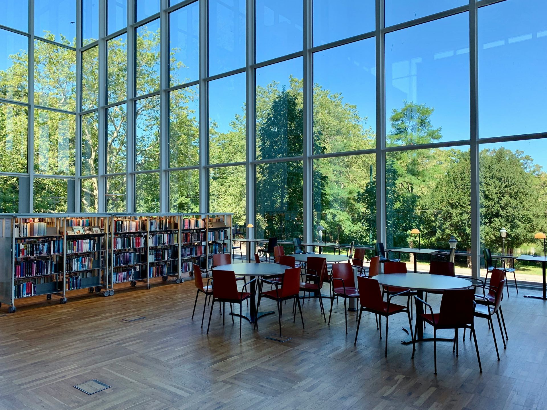 Rows of empty chairs face a stage in a large, empty conference room.