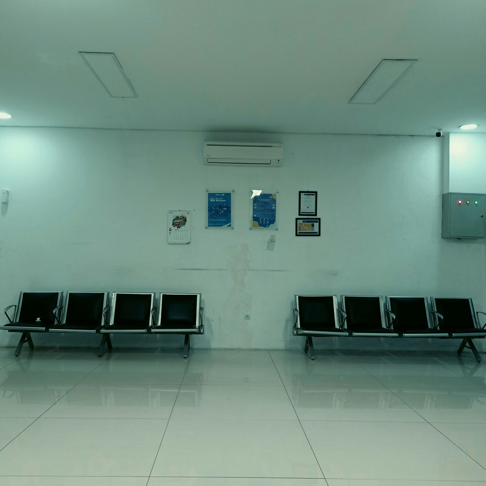 Bank teller booths with brass rails and globe lamps, interior shot.