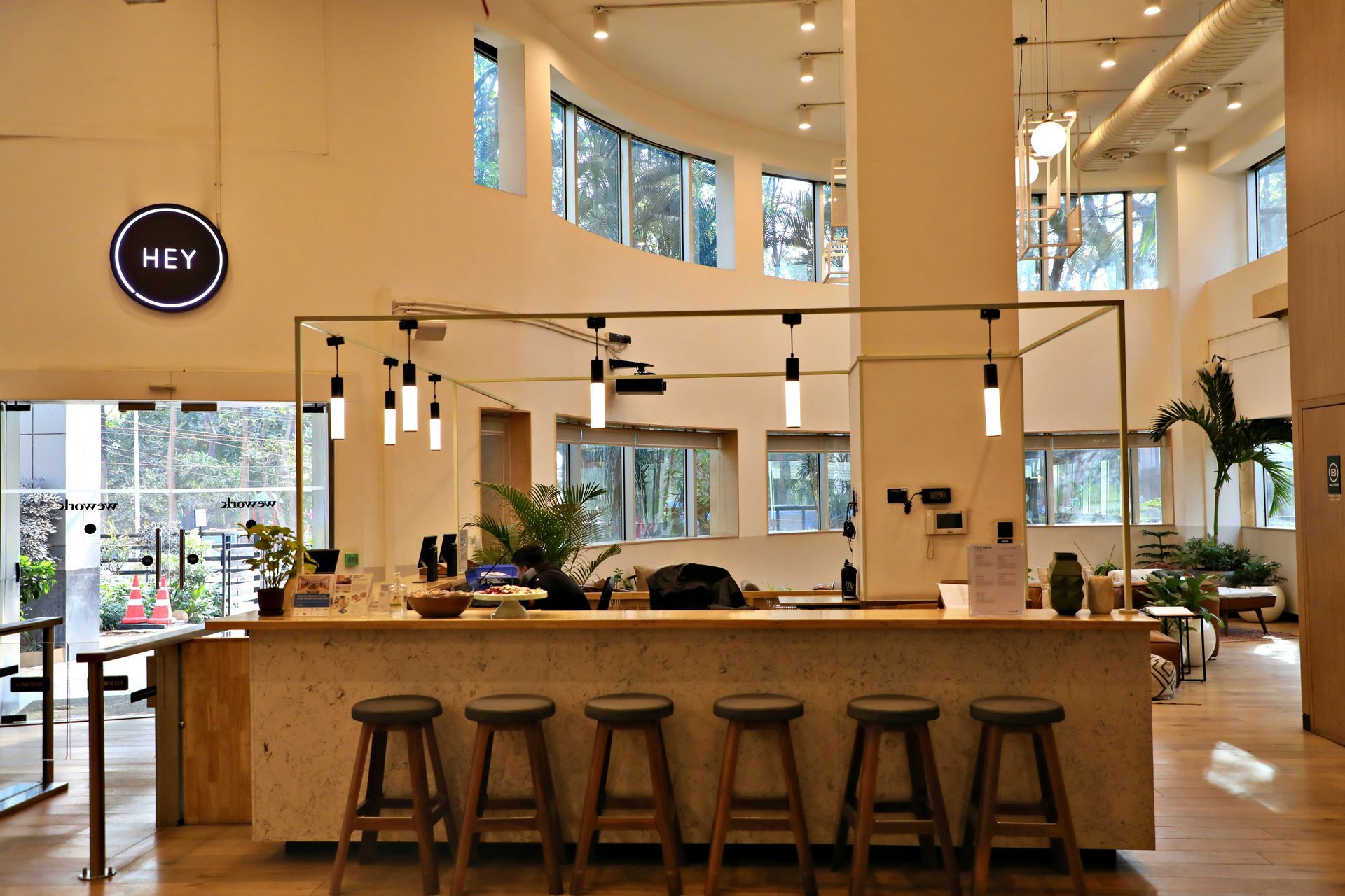 Reception area with bar stools, counter, and large windows.