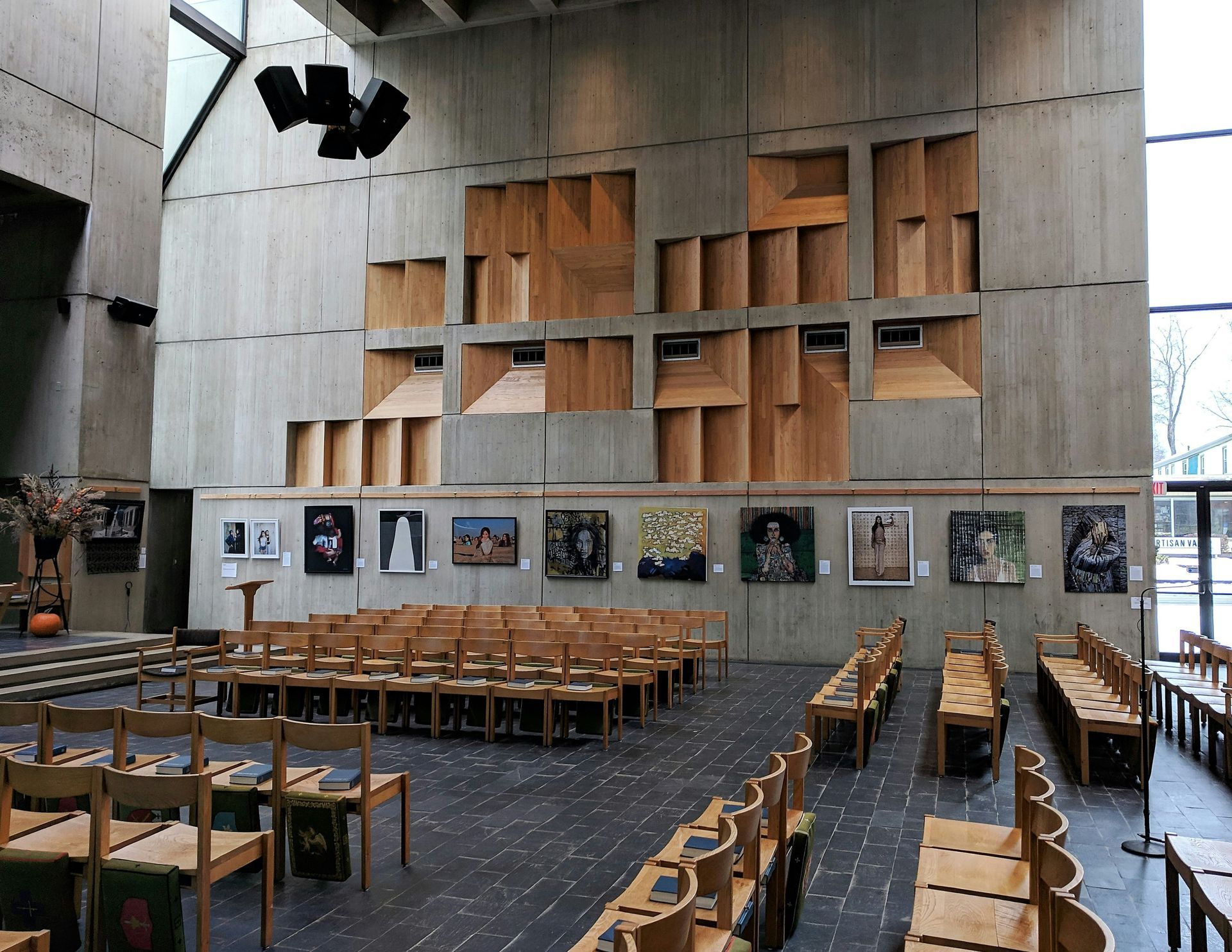 Warehouse interior with forklifts moving pallets, rows of storage racks, and concrete floor.