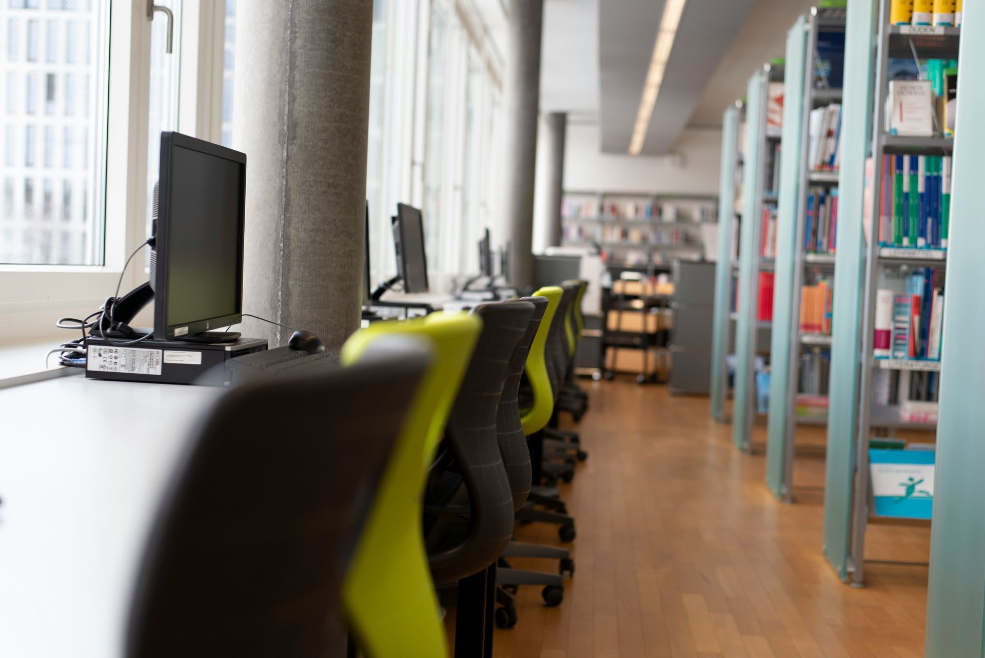 Rows of empty chairs face a stage in a large, empty conference room.