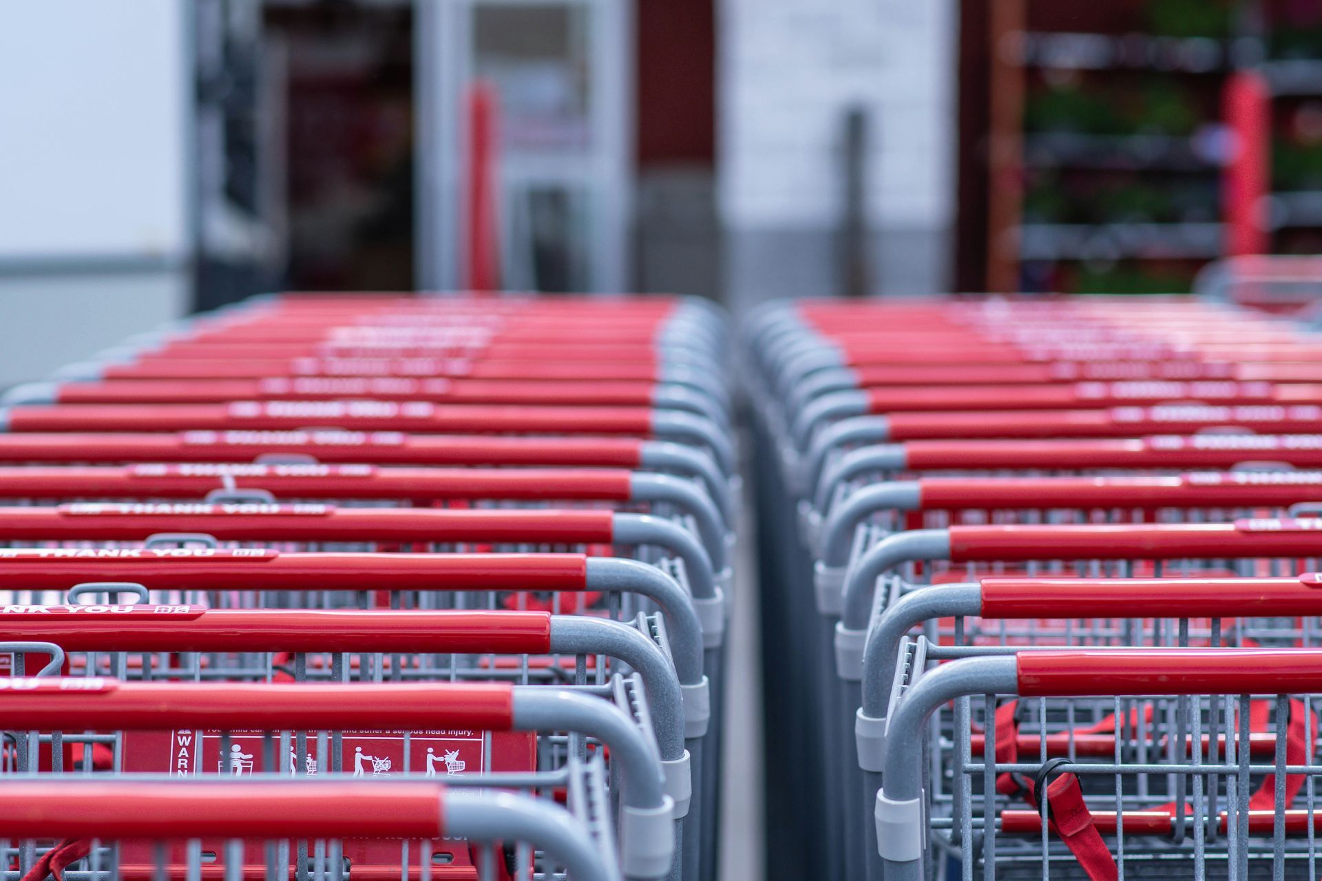 Red shopping carts lined up outside a store.