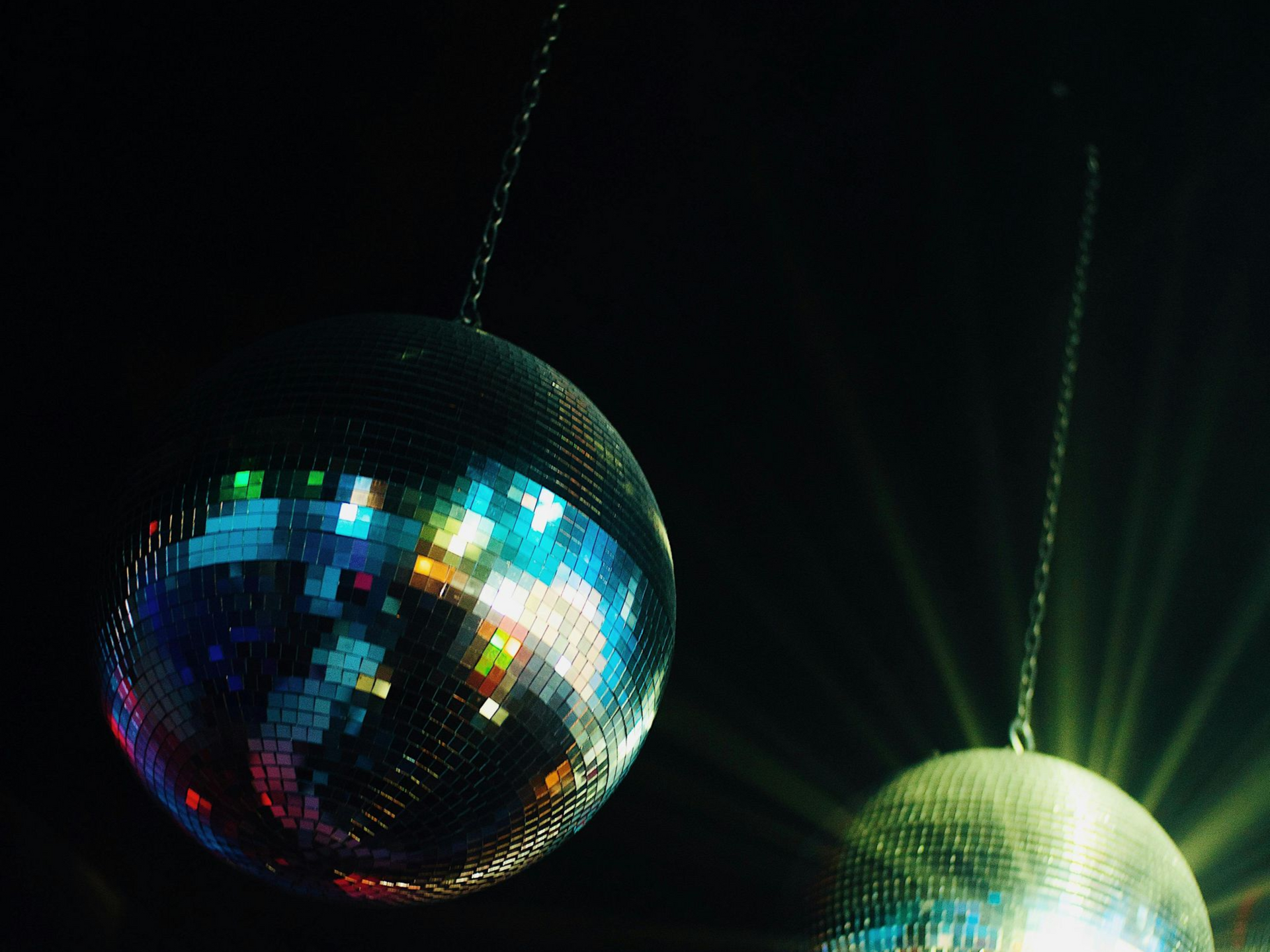 Awaiting area with rows of chairs, red flooring, white columns, and a muted color scheme.