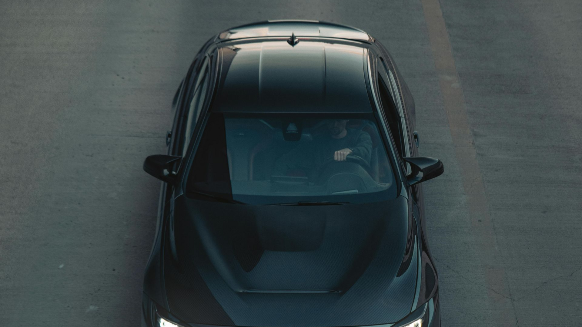 Black car driving on Star road going to Noble Clean, a Professional Cleaning Services in Star, top view, driver visible.