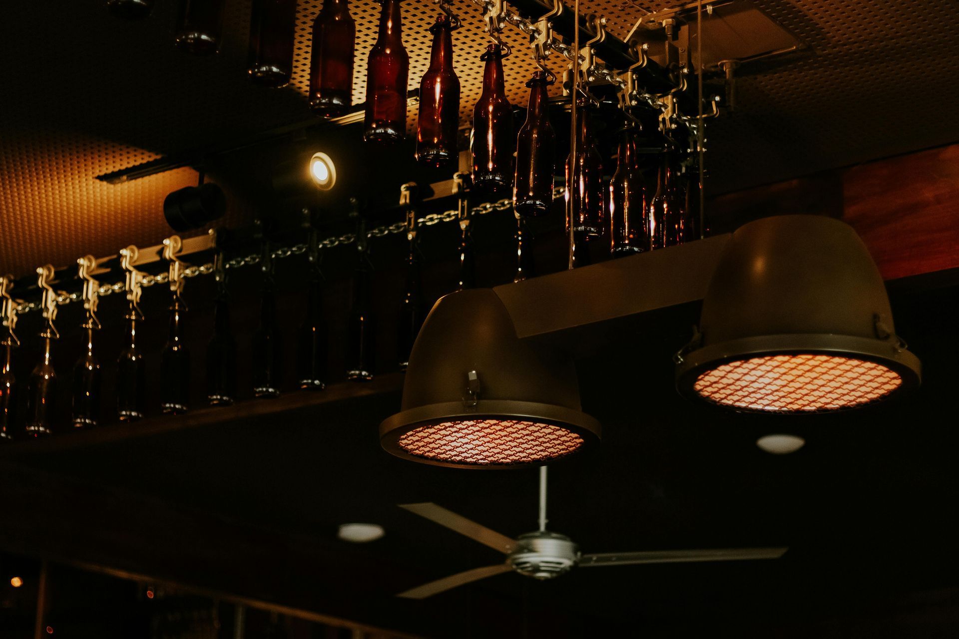 Awaiting area with rows of chairs, red flooring, white columns, and a muted color scheme.