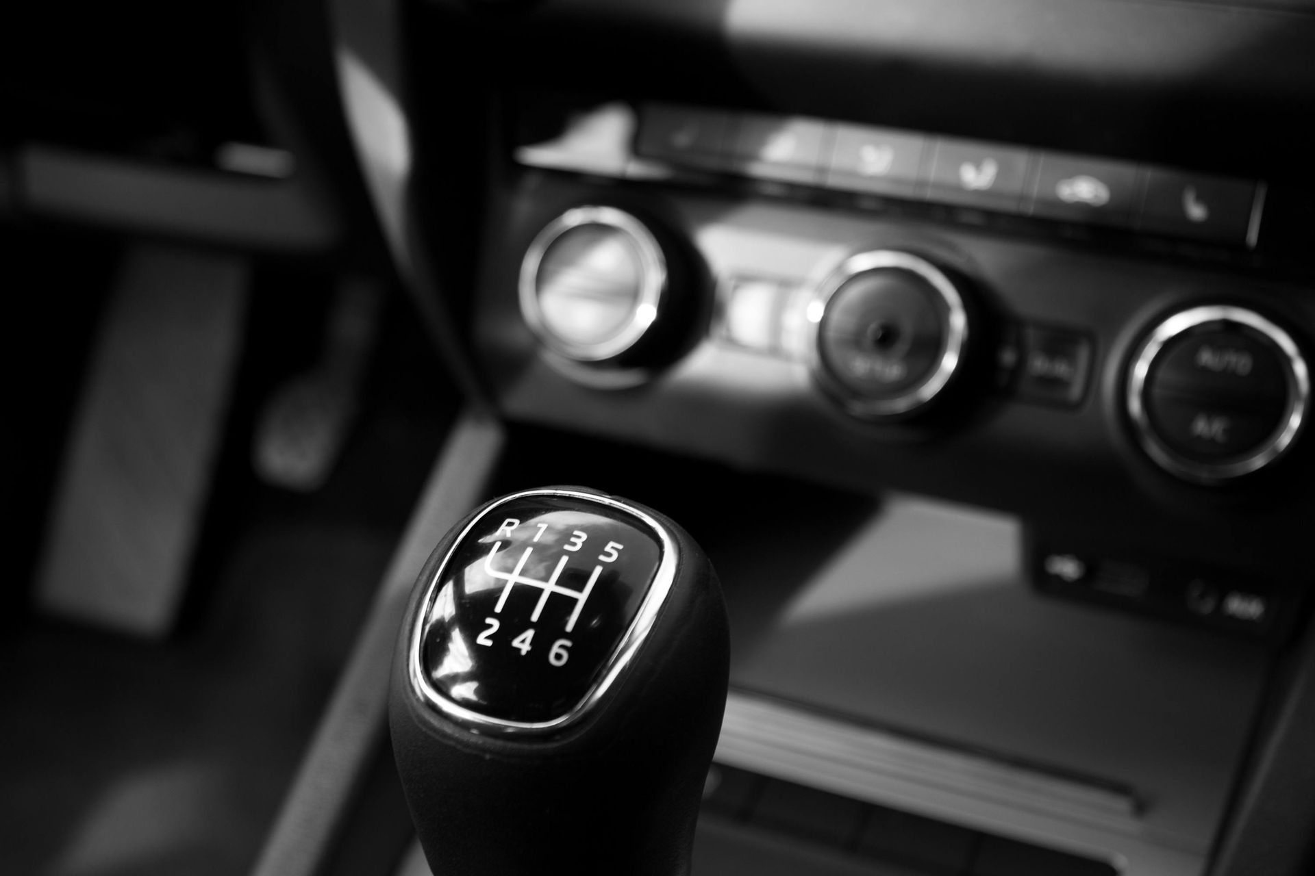 Manual car gear stick with six gears, centered. Climate control knobs visible in the background. This has been cleaned well with Noble Clean Cleaning Services in Nampa