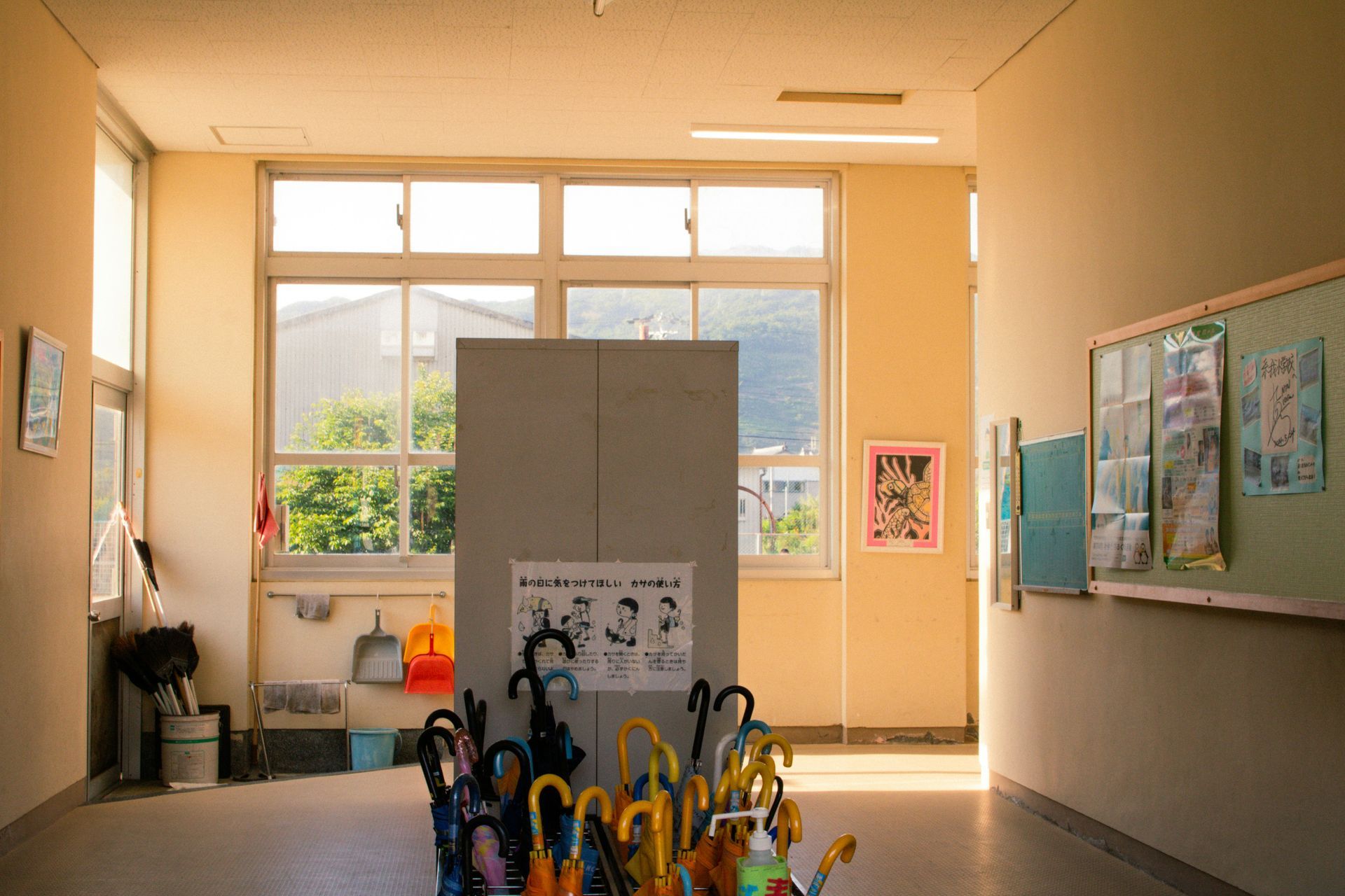 Wooden church pews in a dimly lit room, with a beam of light shining across them.