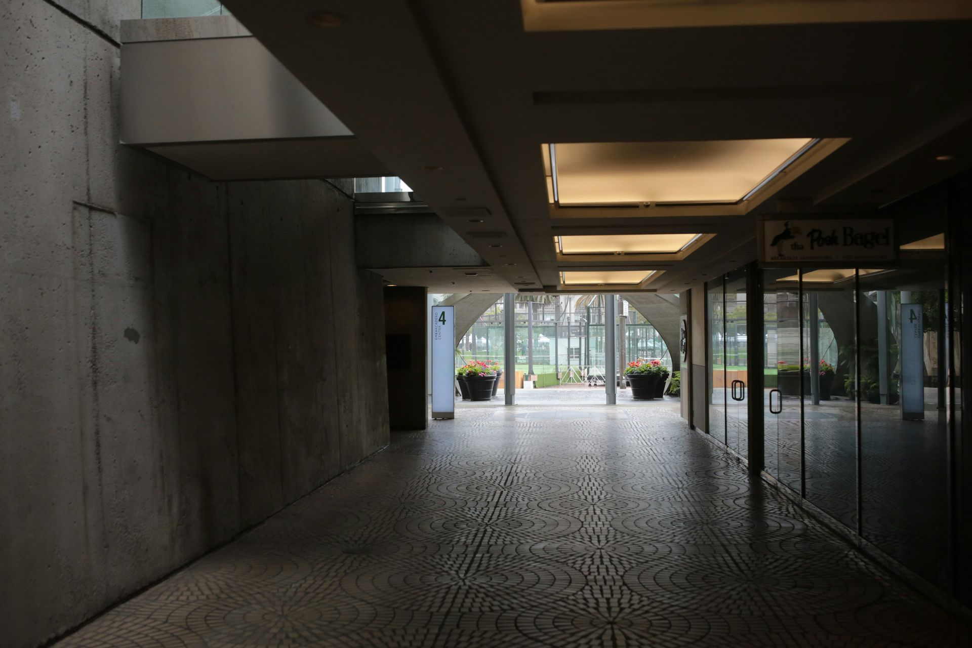 Rows of empty chairs face a stage in a large, empty conference room.