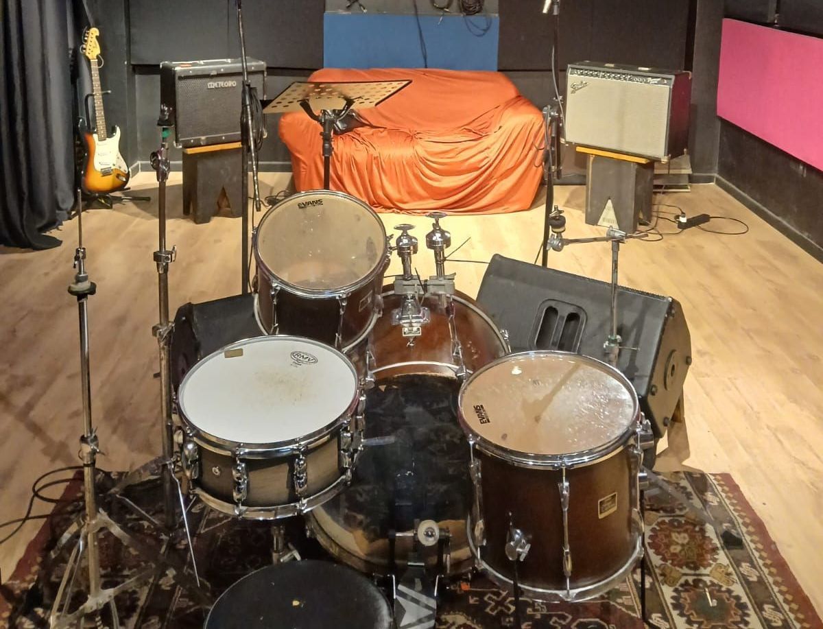 Uma bateria está sobre um tapete em uma sala