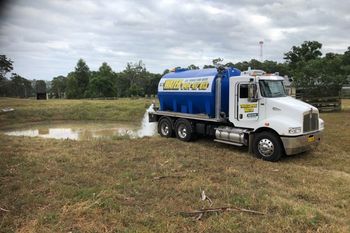 truck filling pond with water