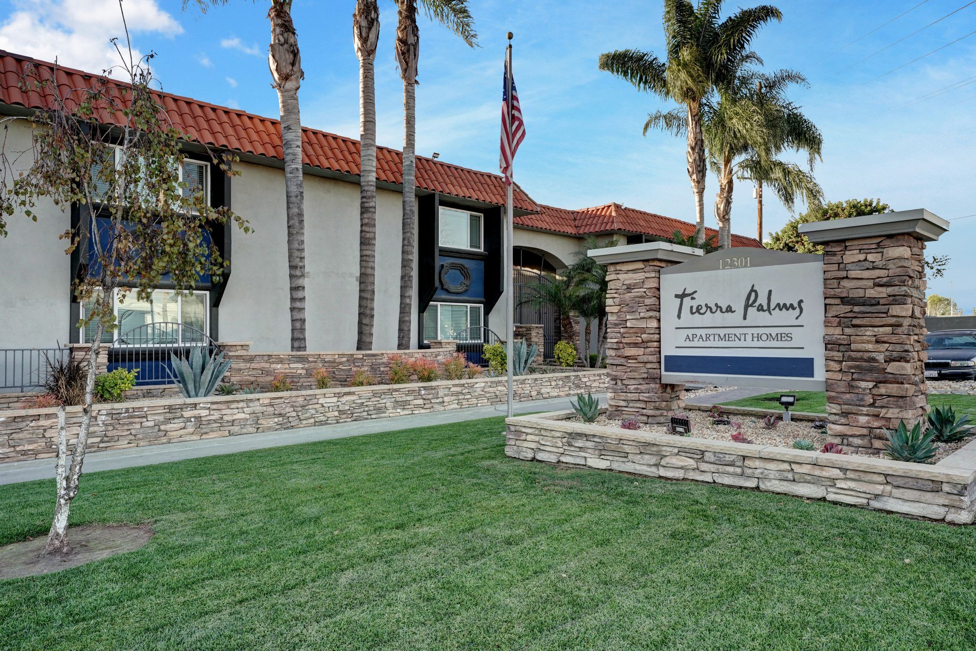 A large white building with a sign in front of it.