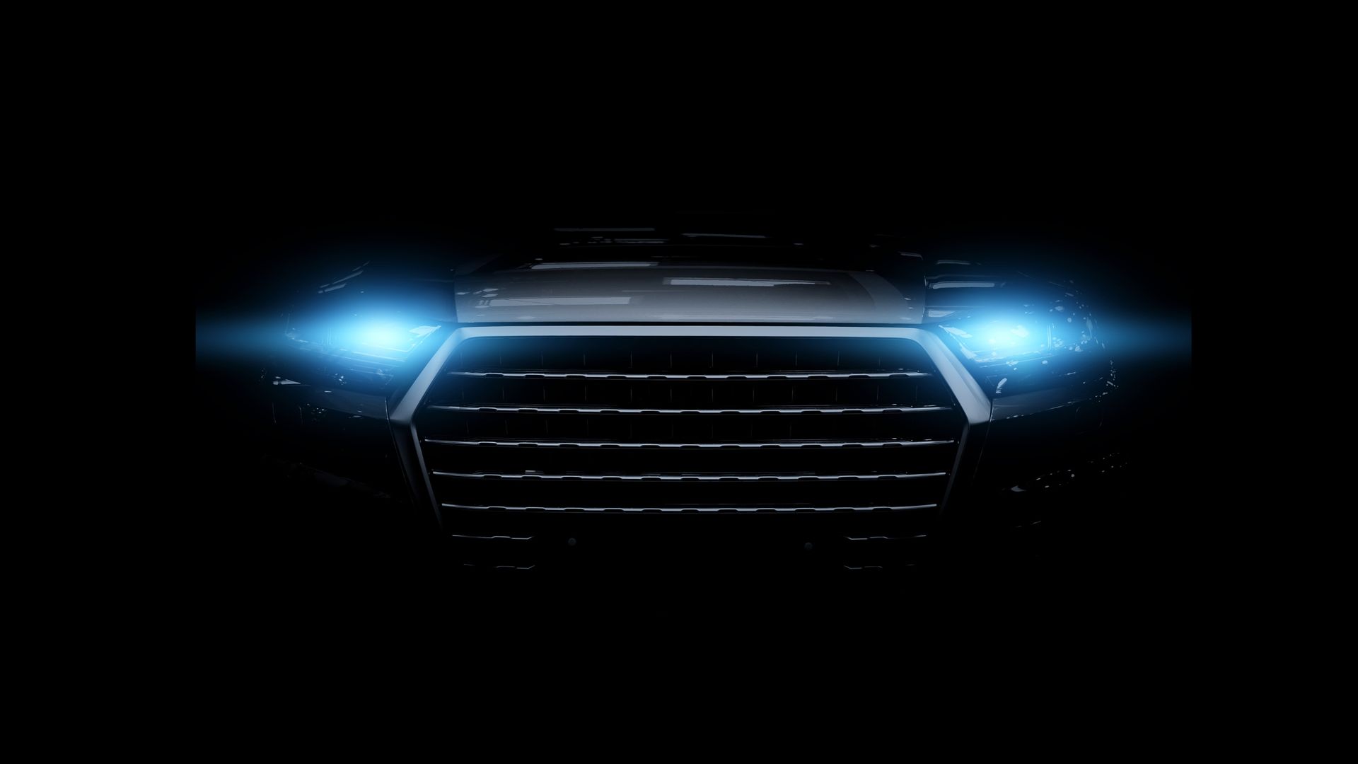 A close up of a car 's headlights in the dark.