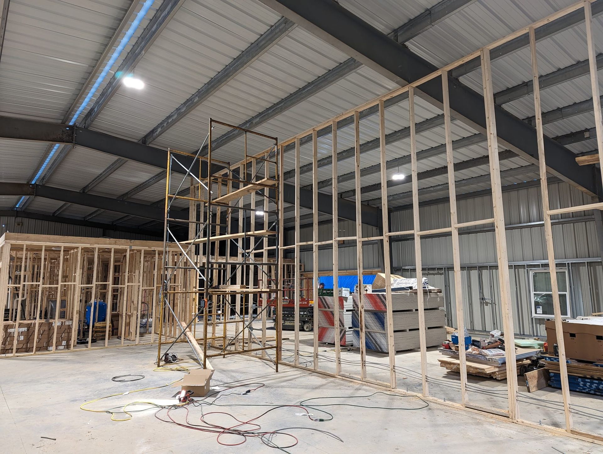 A large building under construction with wooden walls and scaffolding.