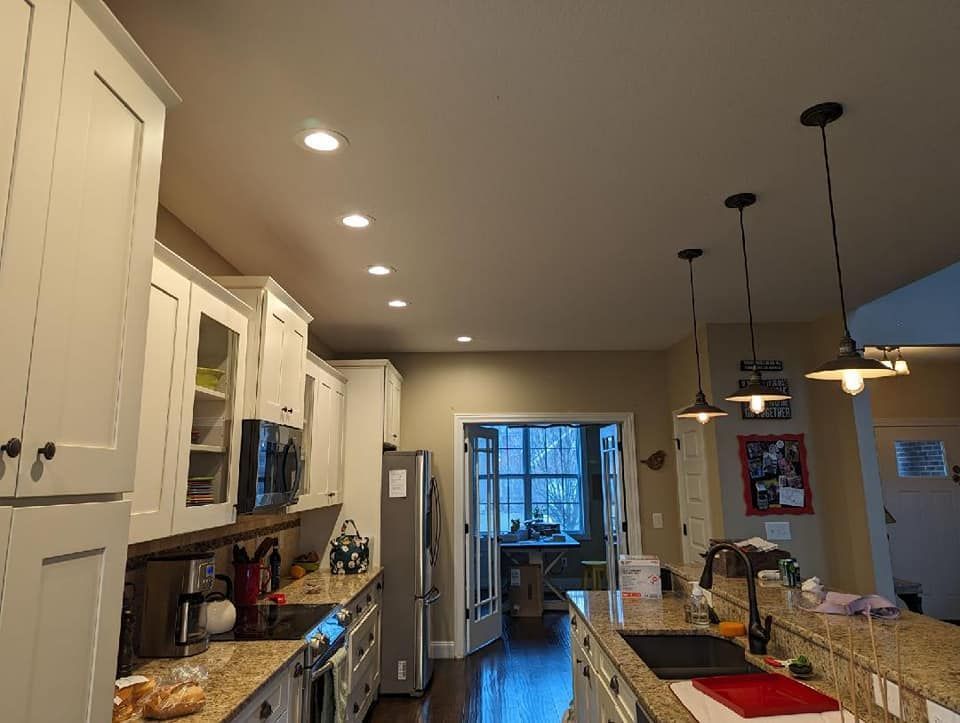 A kitchen with white cabinets and granite counter tops
