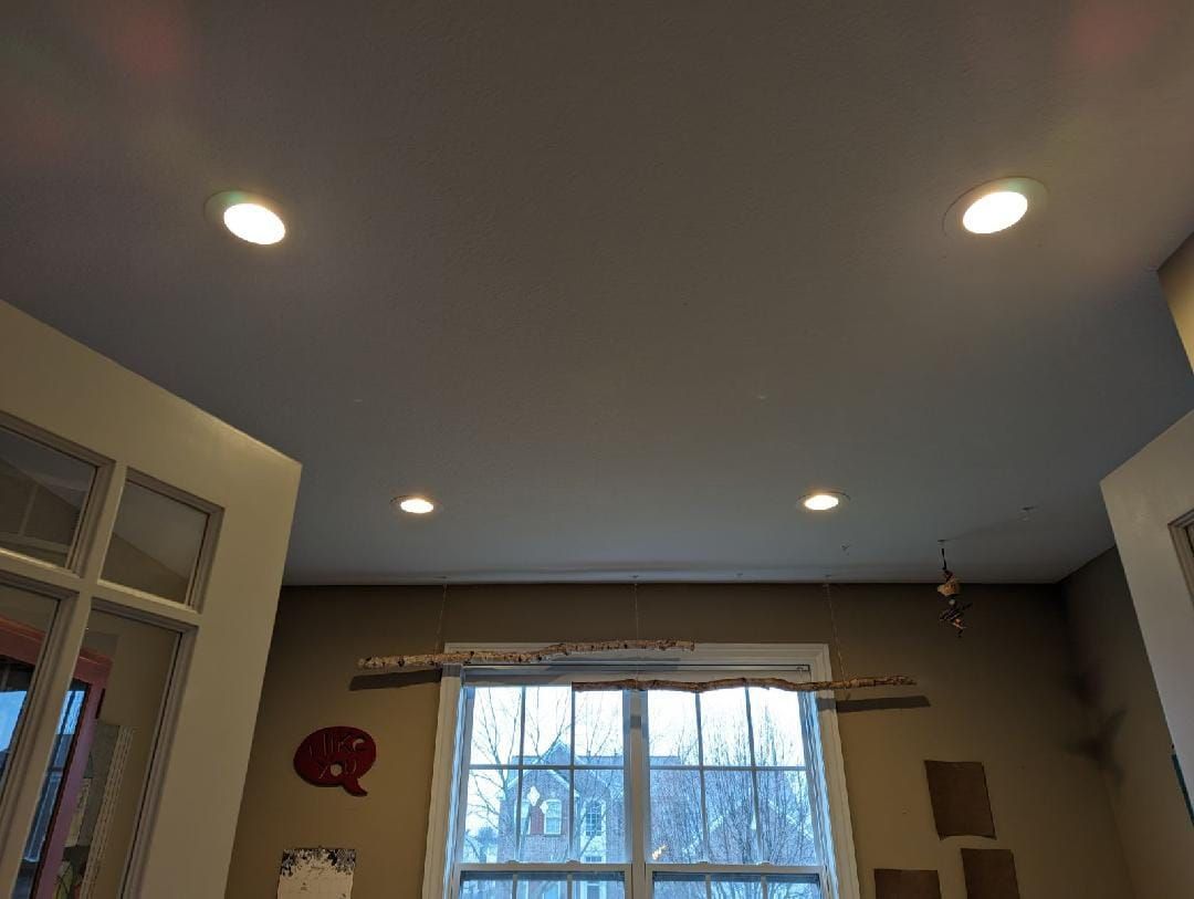 A room with a window and a ceiling with lights on it.