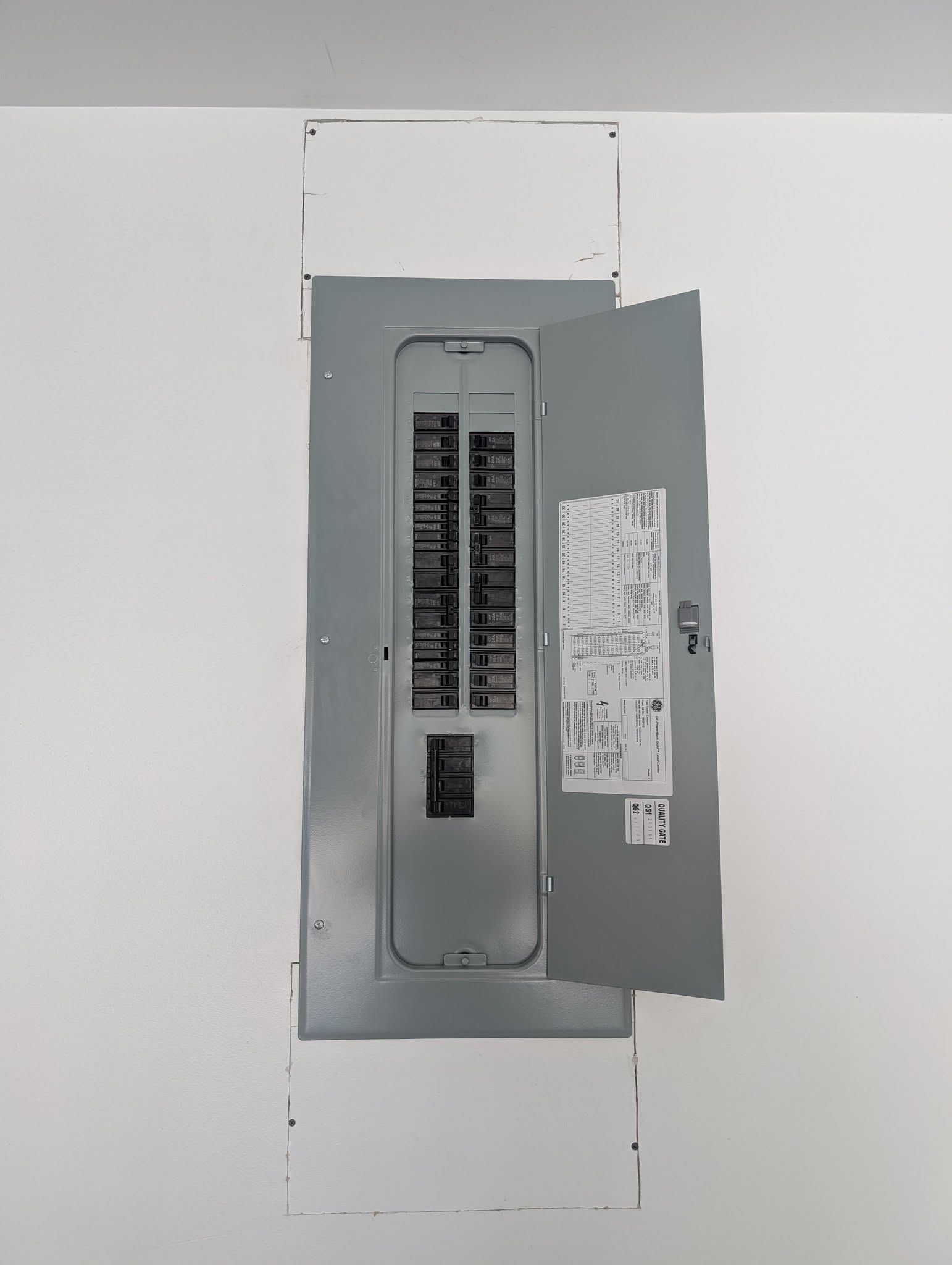 A bedroom with a large bed and a light hanging from the ceiling