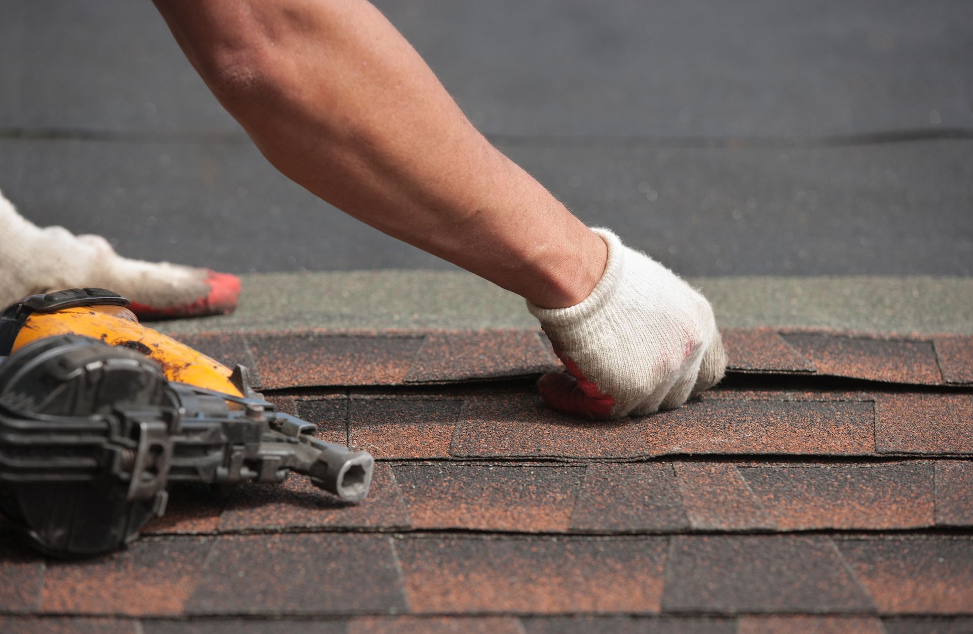 Experienced roofer installing a new roof on a residential home. Experienced roofer installing a new roof on a residential home.