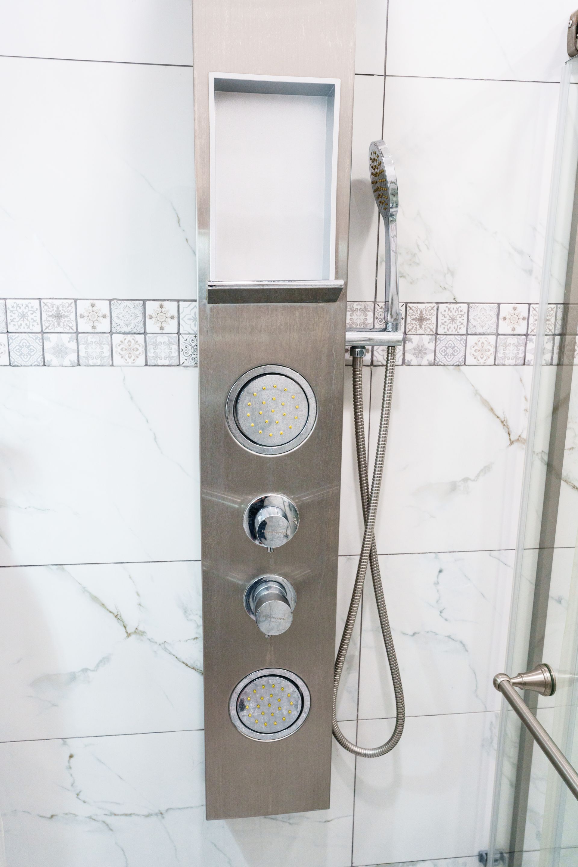 A stainless steel shower hanging from the wall in a bathroom. Somos Hotel San Juan, Puerto Rico Avenida Ponce de Leon
