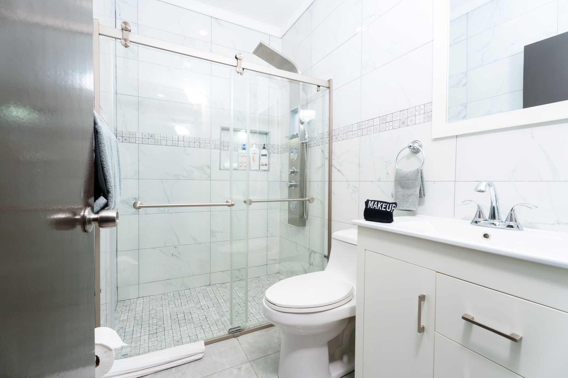A bathroom with a toilet , sink and shower with sliding glass doors. Somos Hotel San Juan, Puerto Rico Avenida Ponce de Leon