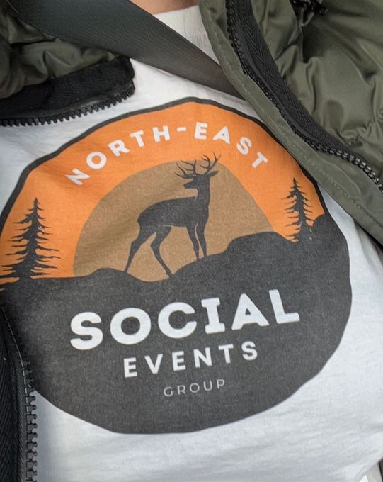 A person is wearing a shirt that says north east social events group