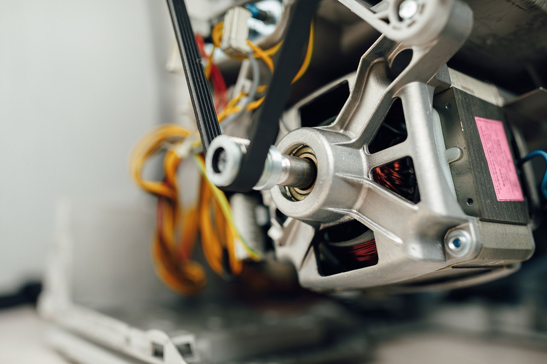 Washing machine motor with belt and pulley system.