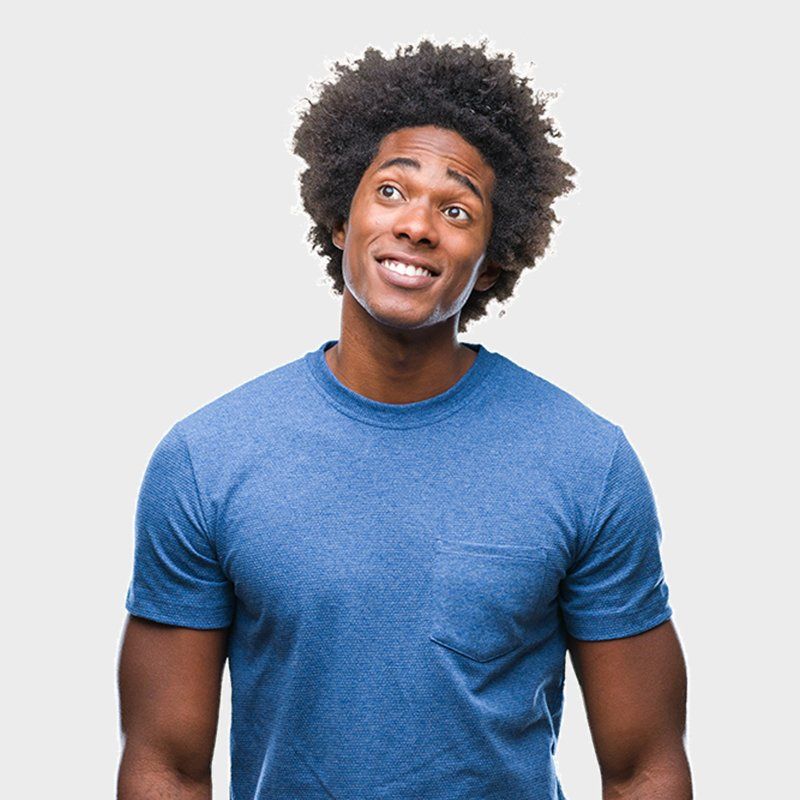 A man in a blue t-shirt is smiling and looking up.