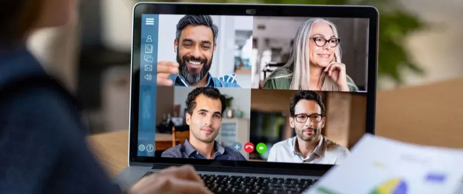 A group of people are having a video call on a laptop computer.
