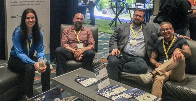 A group of people are sitting around a table in a room.