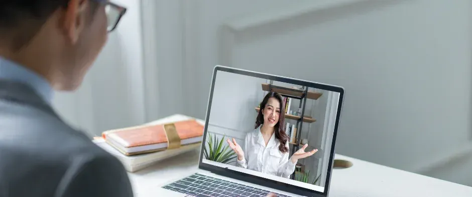 A woman is having a video call on a laptop computer.