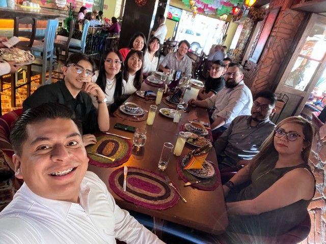 A group of people are sitting around a table in a restaurant.