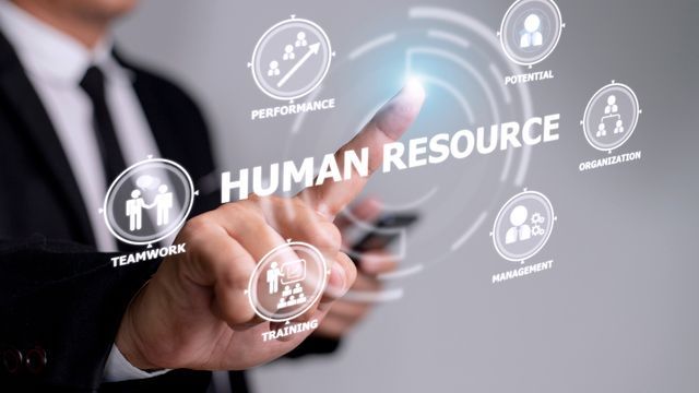 A man is pressing a button on a screen that says human resource.