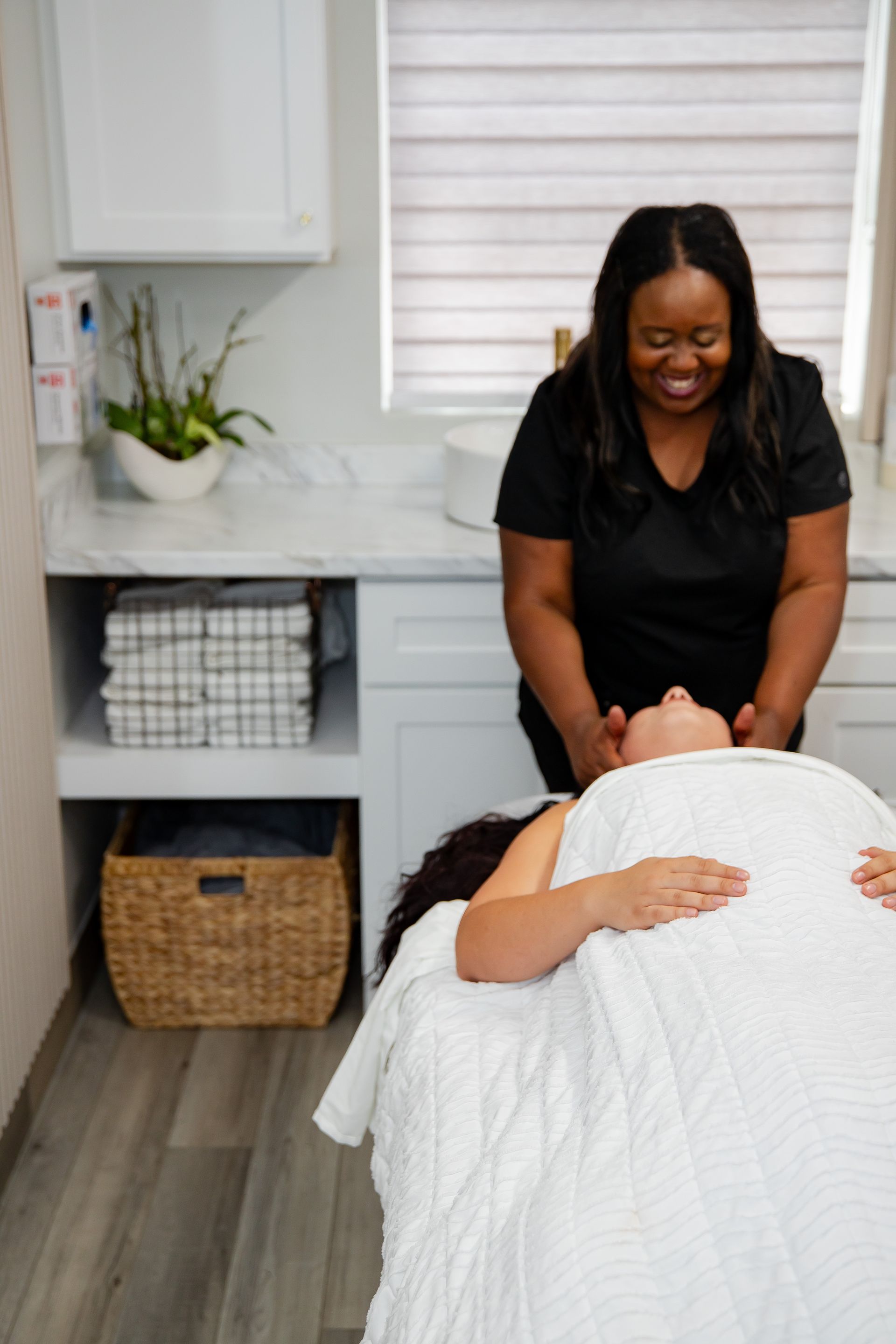 A woman is laying on a massage table getting a massage.