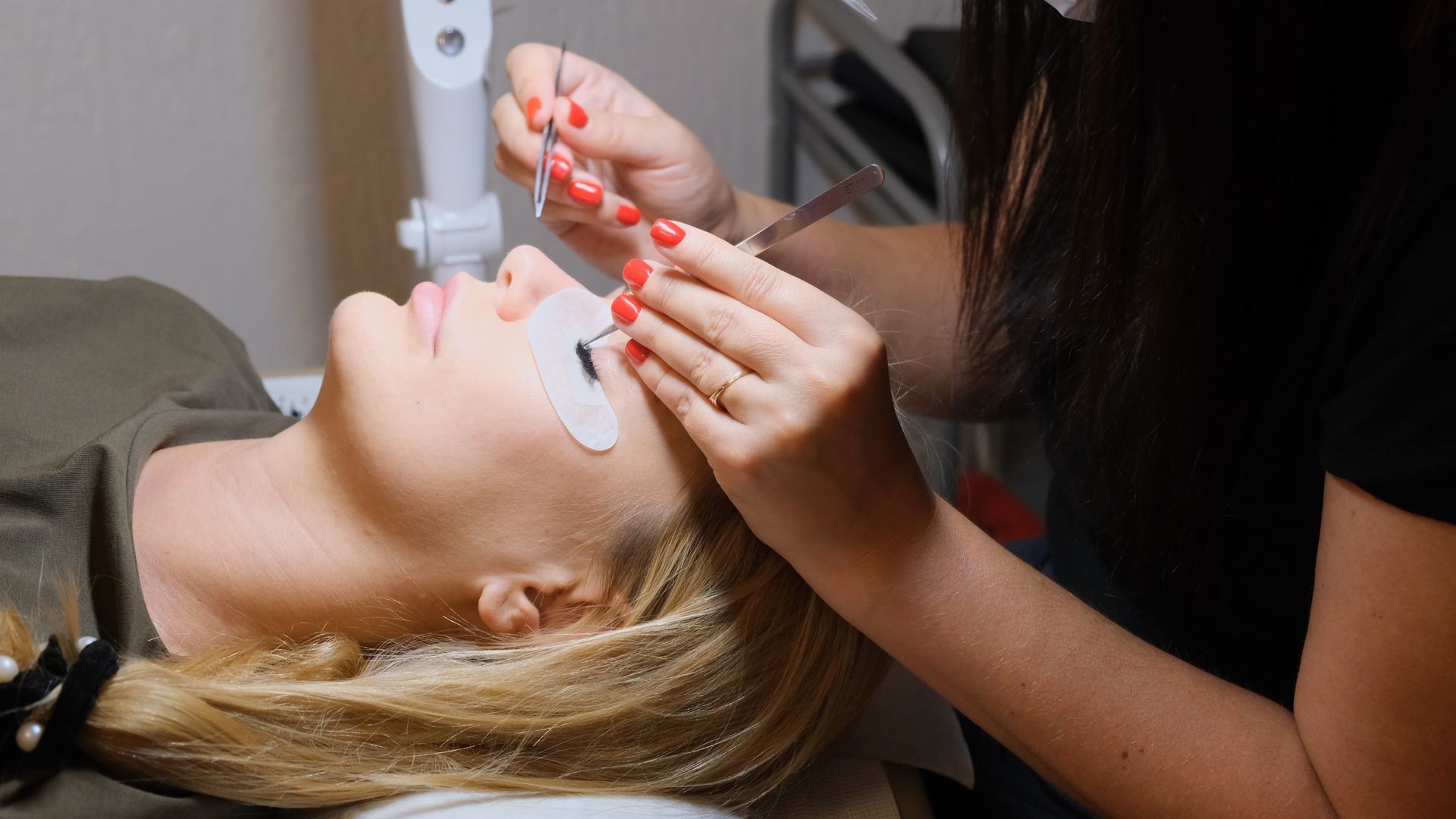 A woman is getting her eyelashes done at a beauty salon.