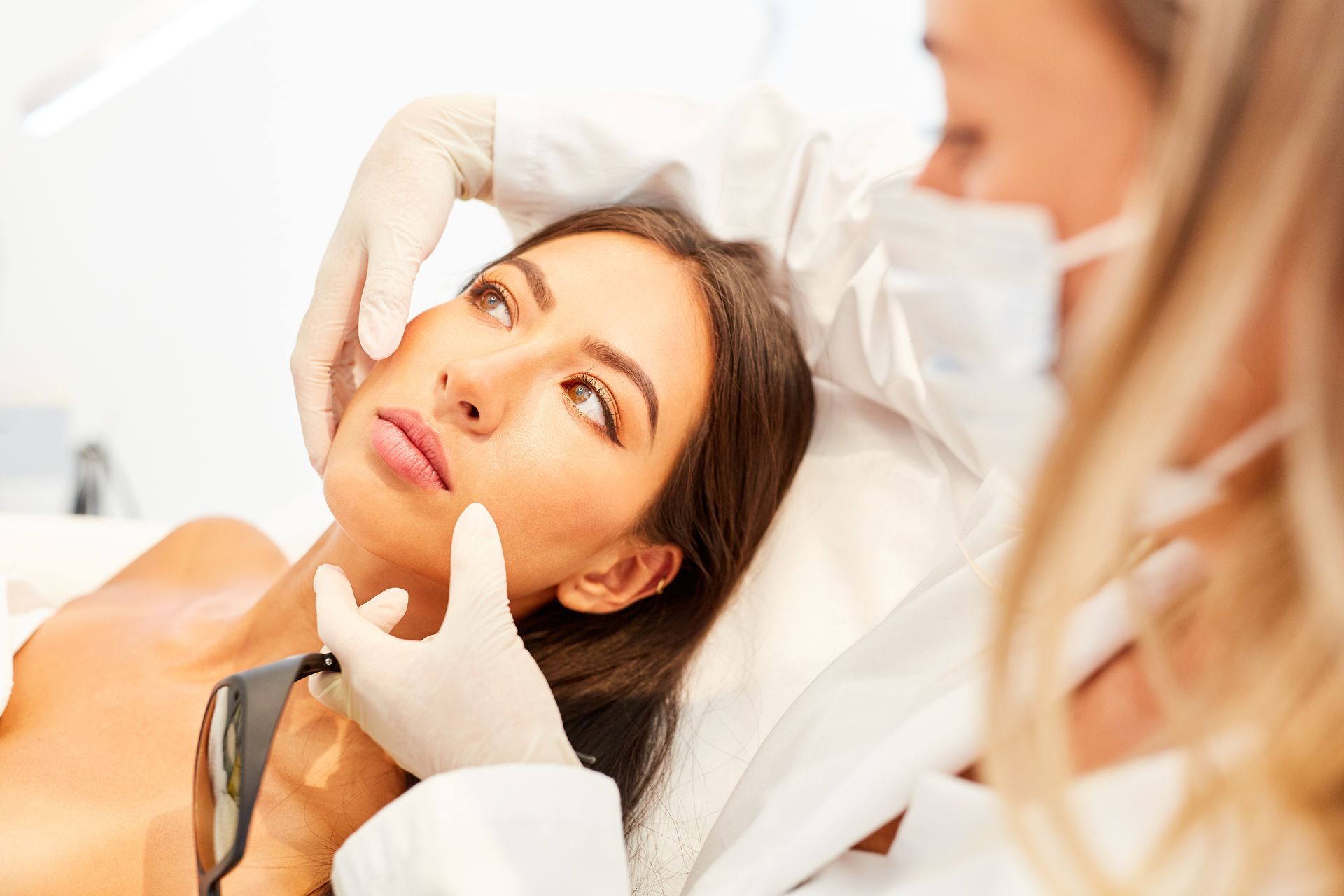 A woman is getting a botox injection in her face.