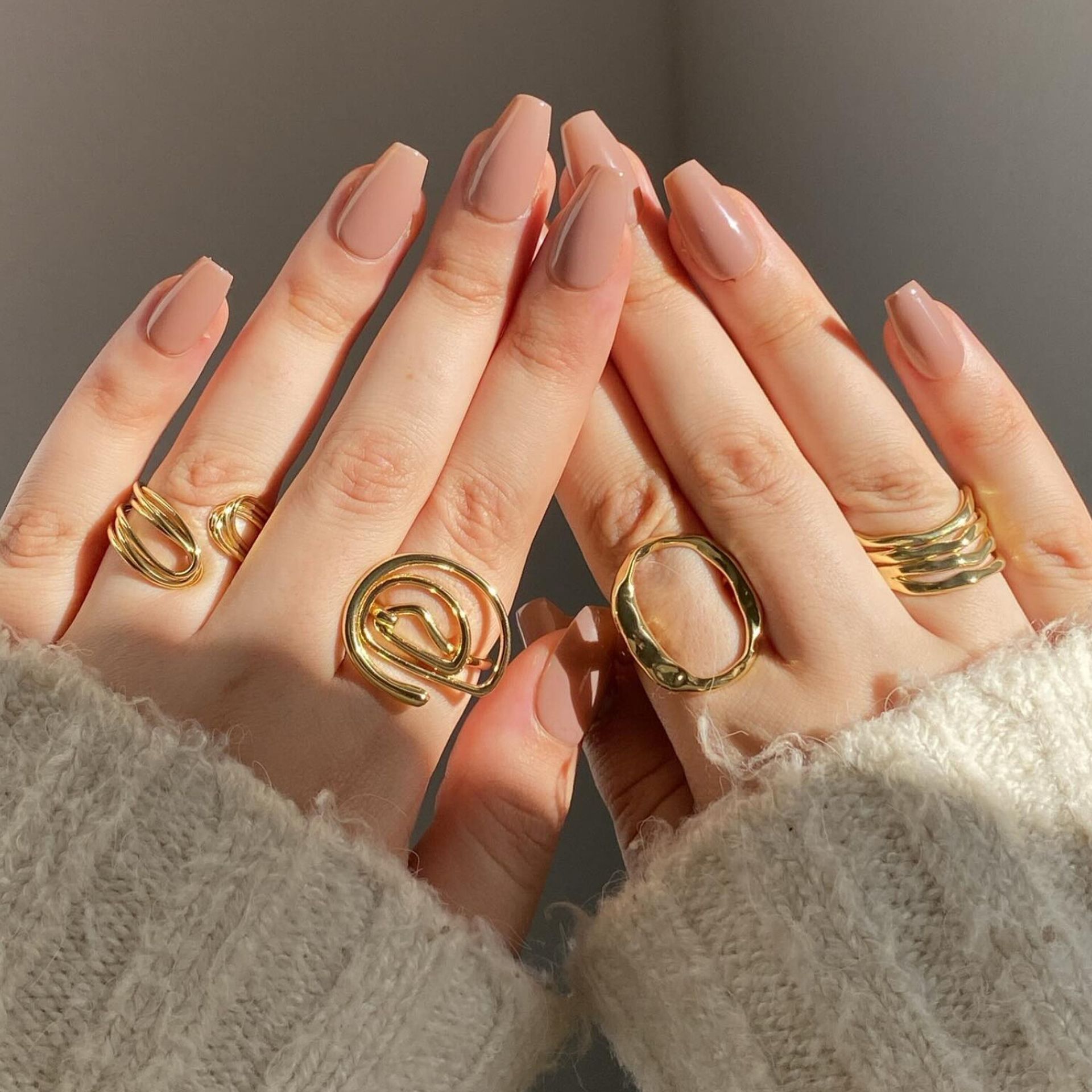 A close up of a woman 's hands with rings on them