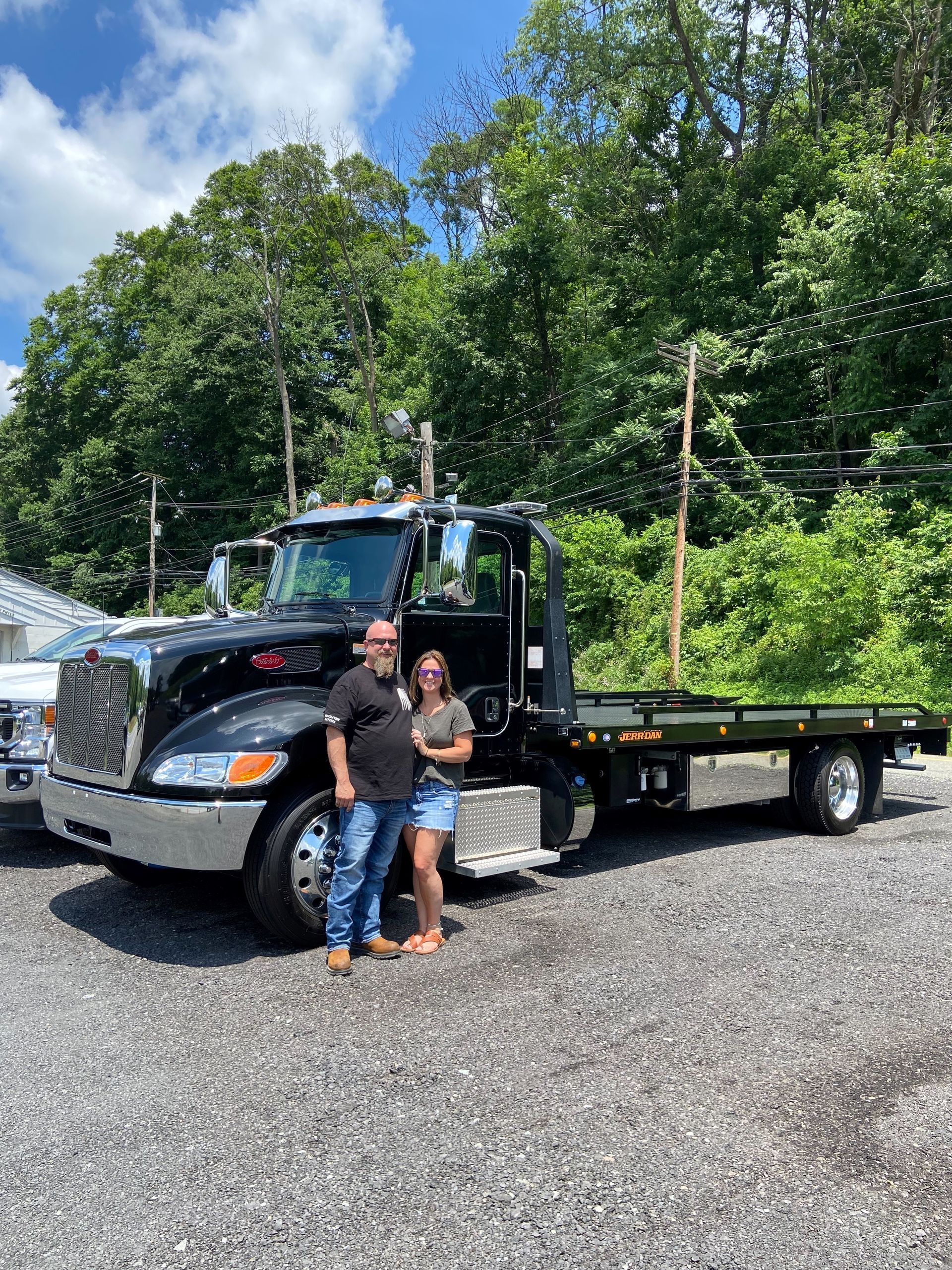 Man and Woman Beside Tow Truck — Deposit, NY — Wheeler’s Collision