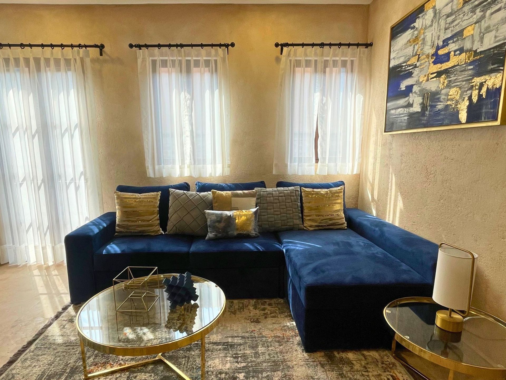 Modern dining room with a table and chairs, a sitting area, and a bar.