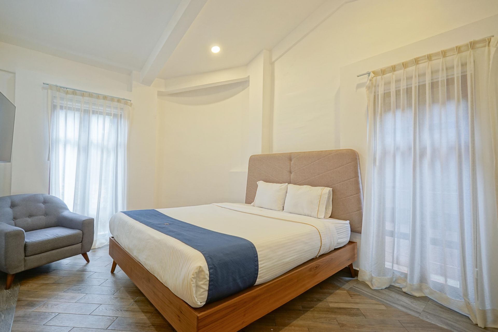 Bedroom with bed, nightstand, and open door to balcony.