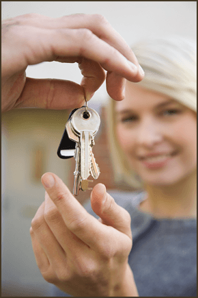  A girl being handed the keys to her new home