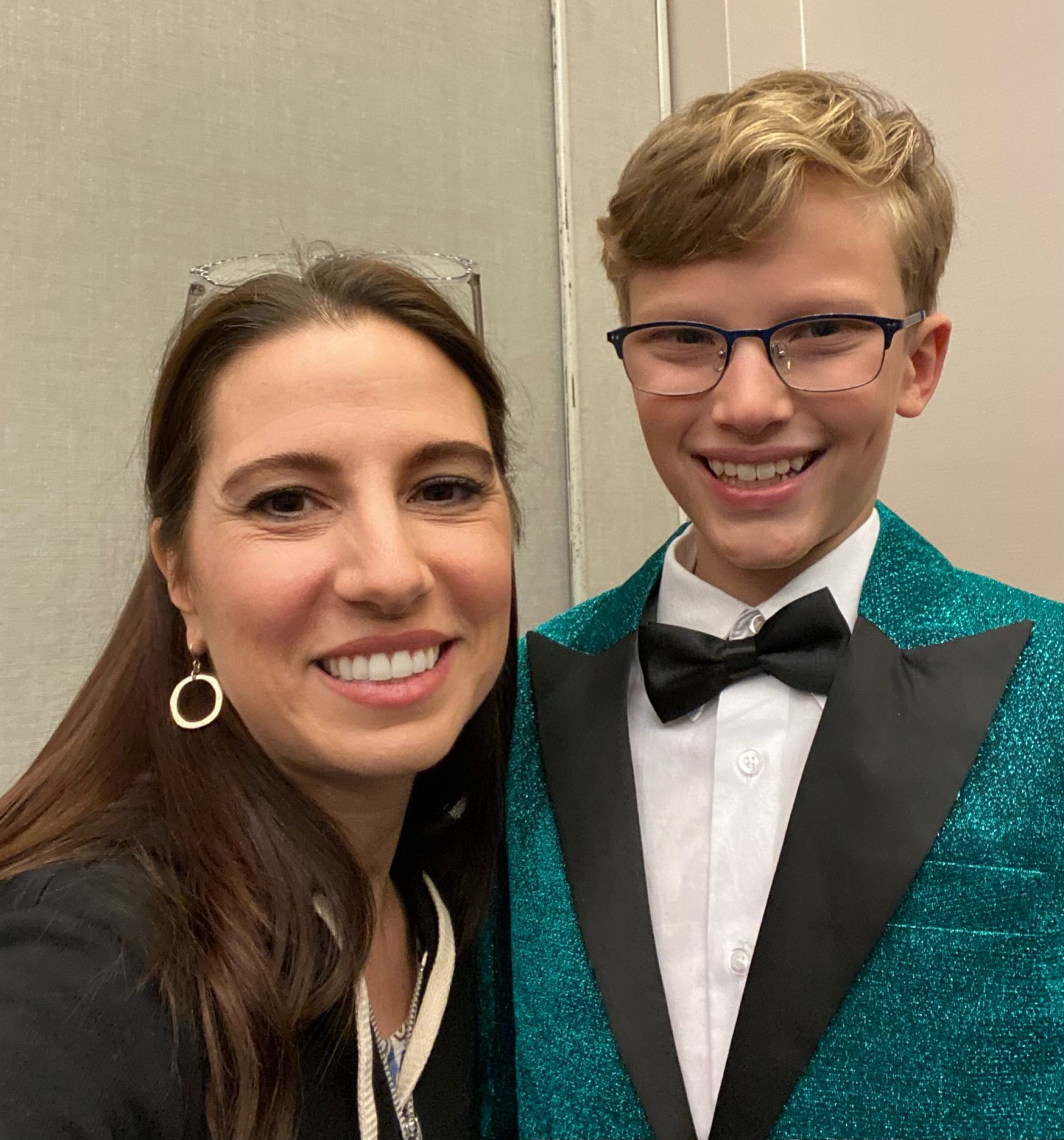 A woman and a boy are posing for a picture