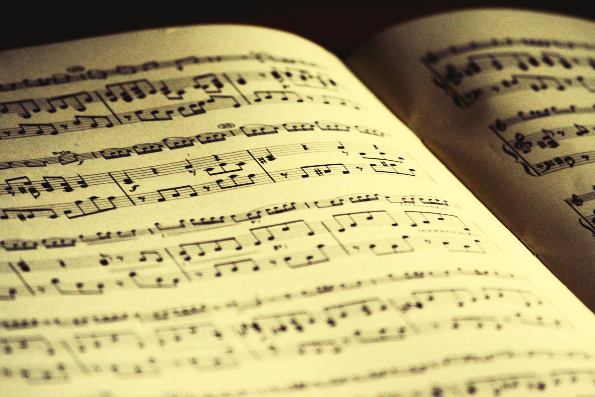 A book is open to a page with music notes on it