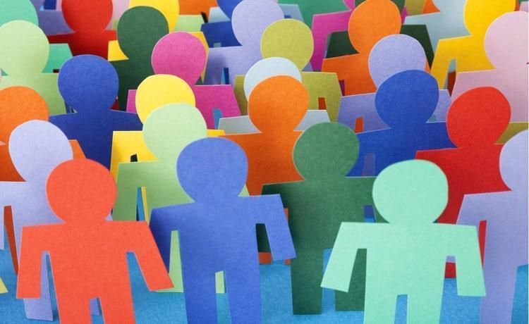 A group of colorful paper people standing next to each other