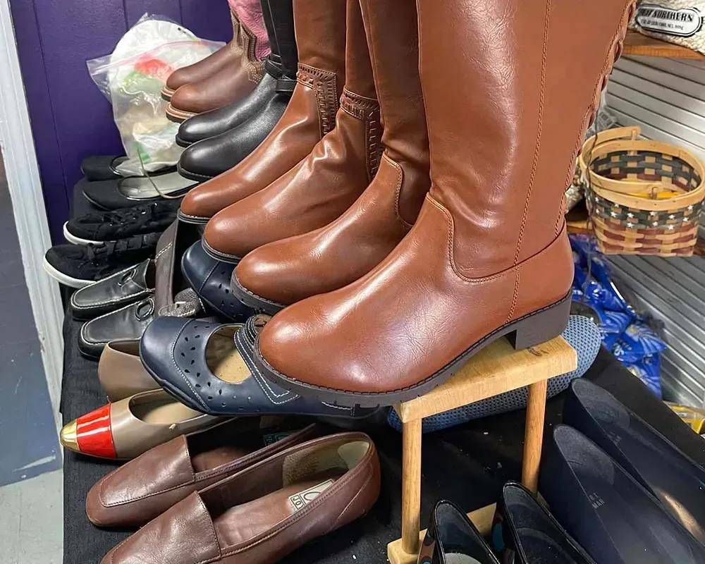Three little girls are sitting on a couch with a baby.