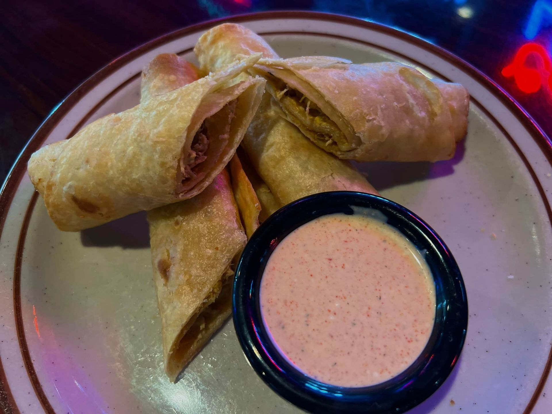 A plate of food with a dipping sauce on it