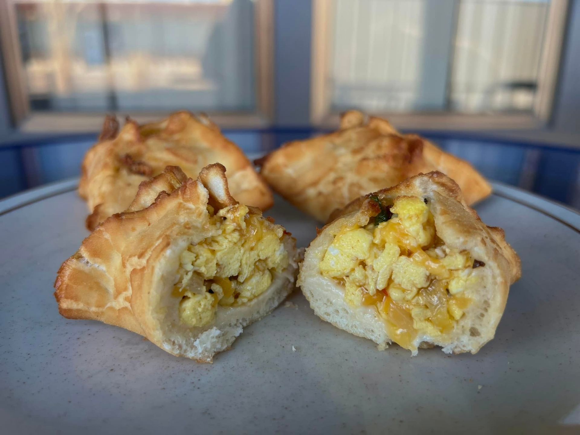 A close up of a piece of food on a plate with a bite taken out of it.