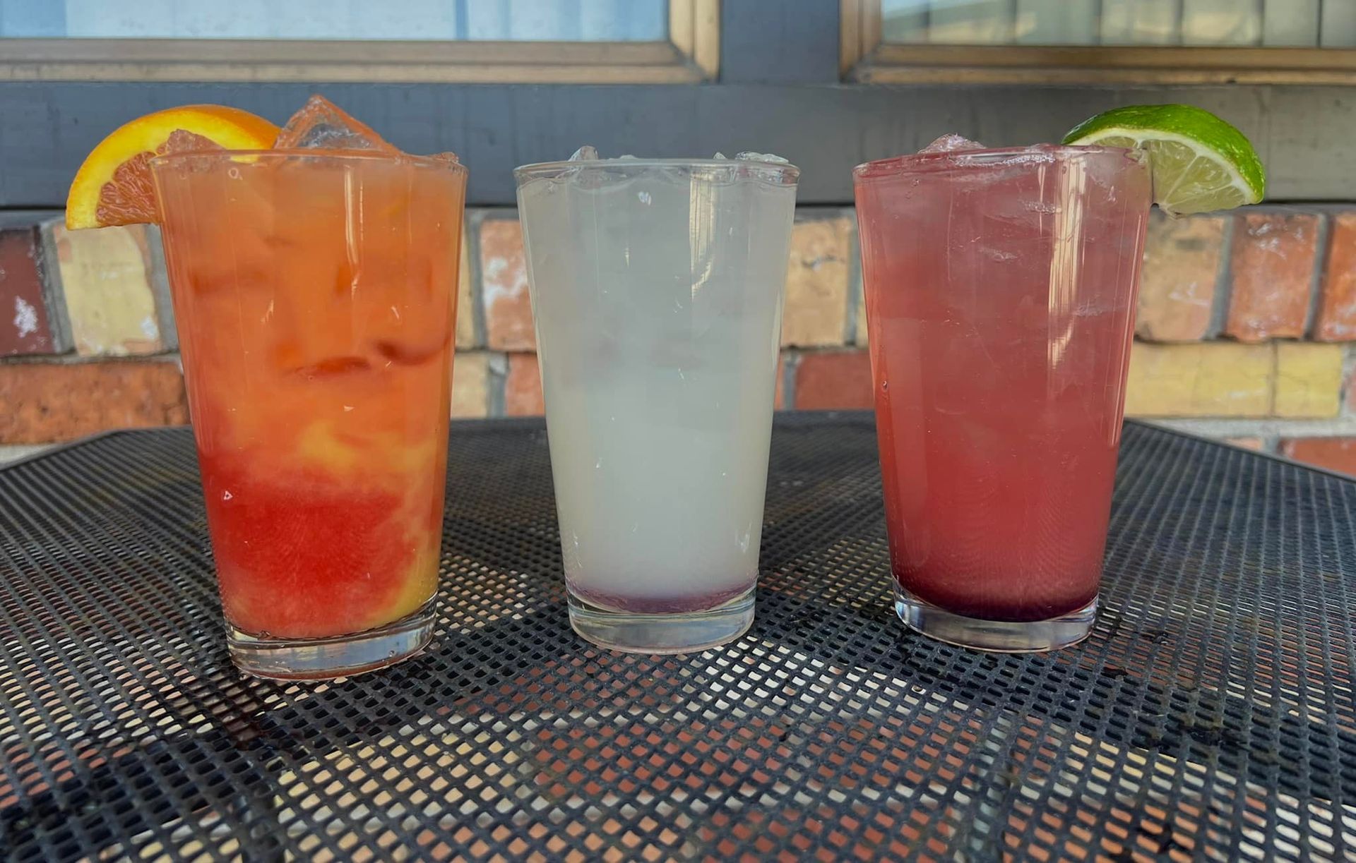 Three different types of drinks are sitting on a table.