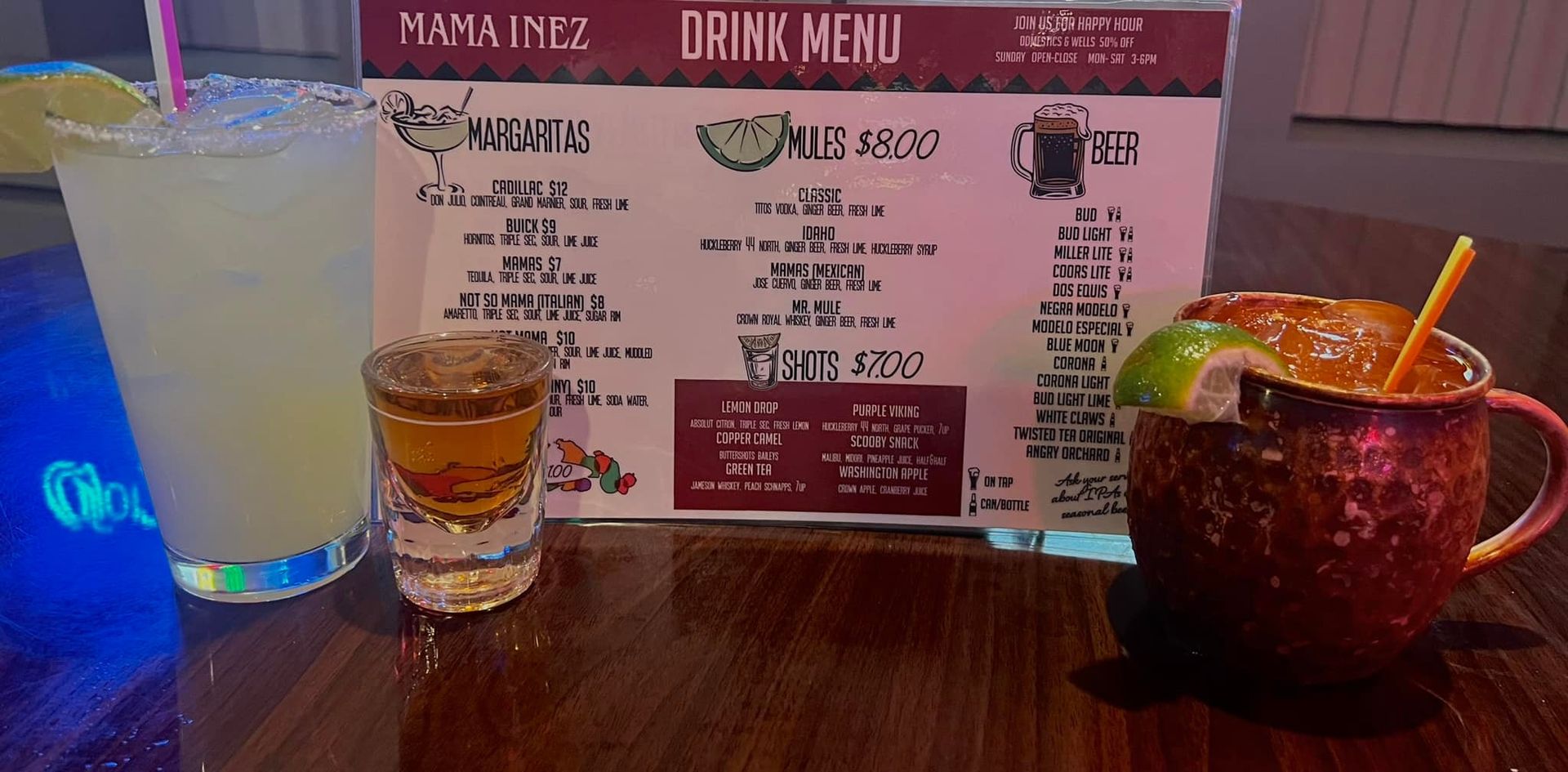 Two drinks are sitting on a table next to a menu.