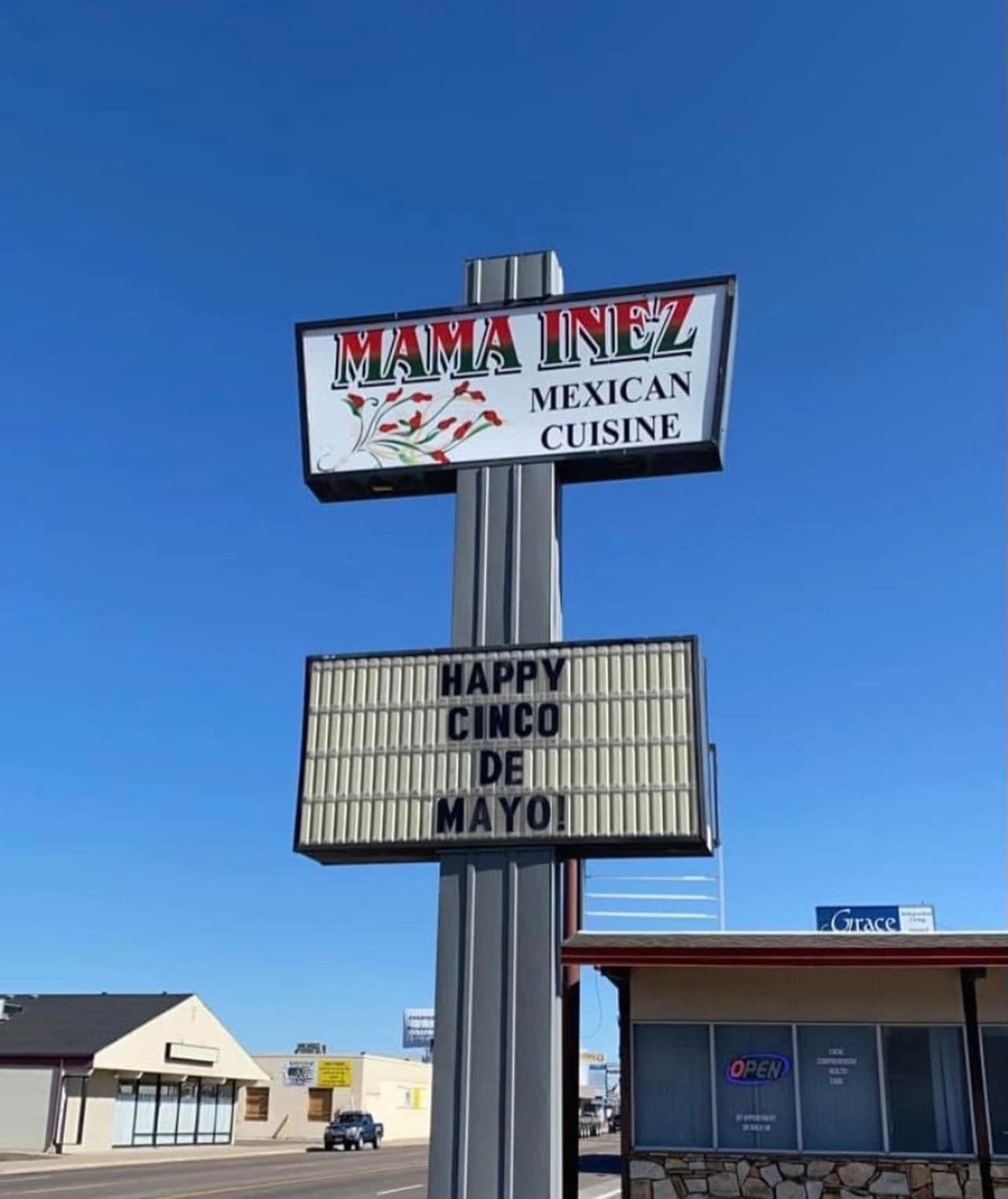 A sign for mama inez mexican cuisine says happy cinco de mayo